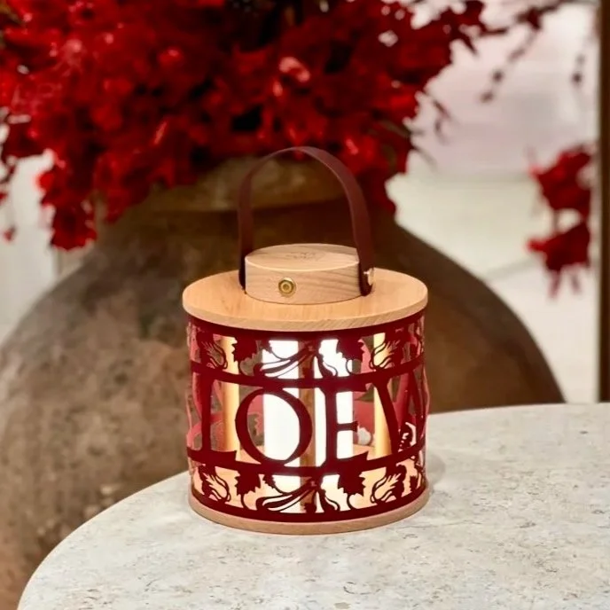 Loewe Singapore x Merremade collaboration. Decorative paper lantern with cut-out leaves and tree design.