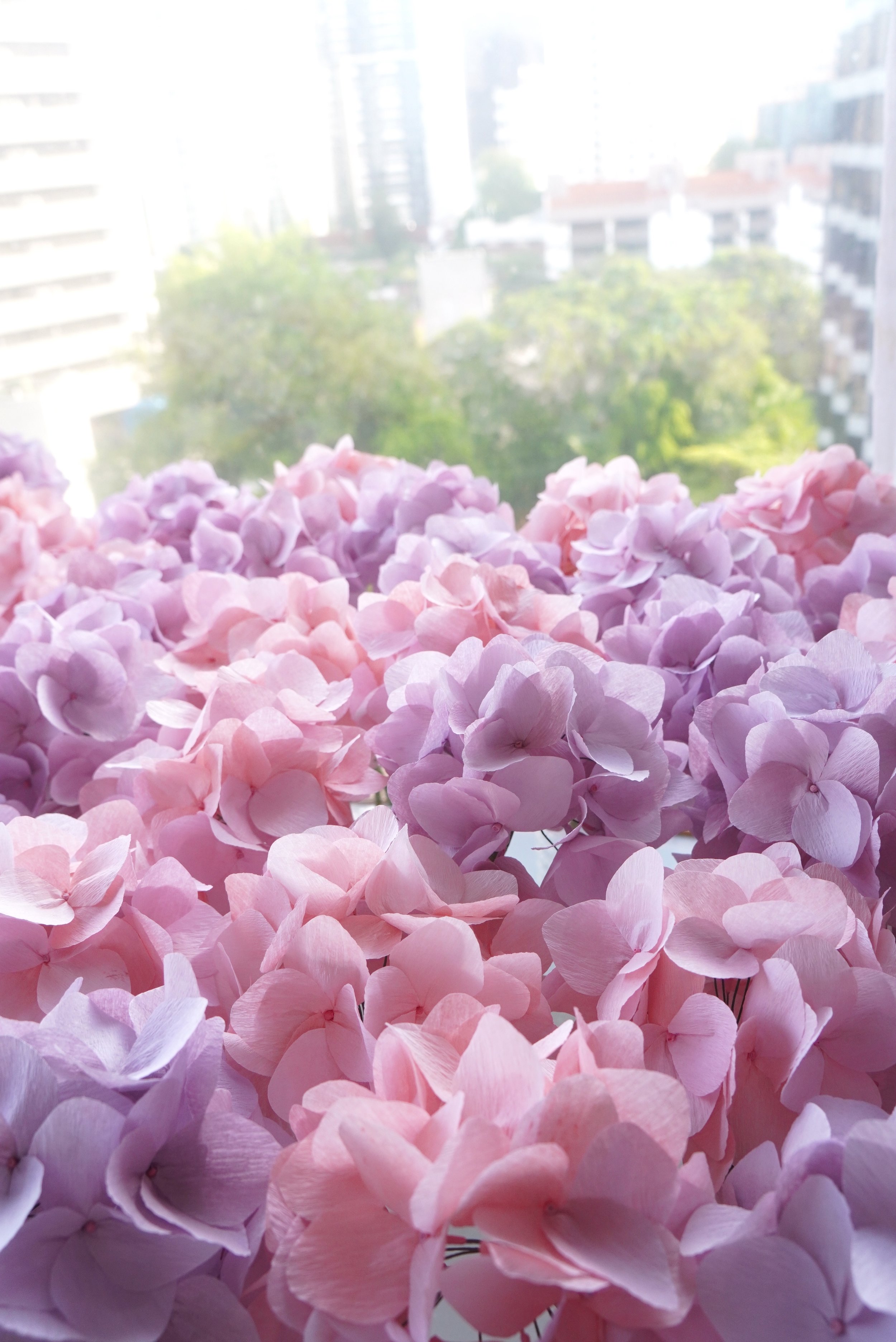 Jasmine Sing, paper artist from Merremade handcrafted these pink and purple paper hydrangeas for Van Cleef & Arpels Singapore. 