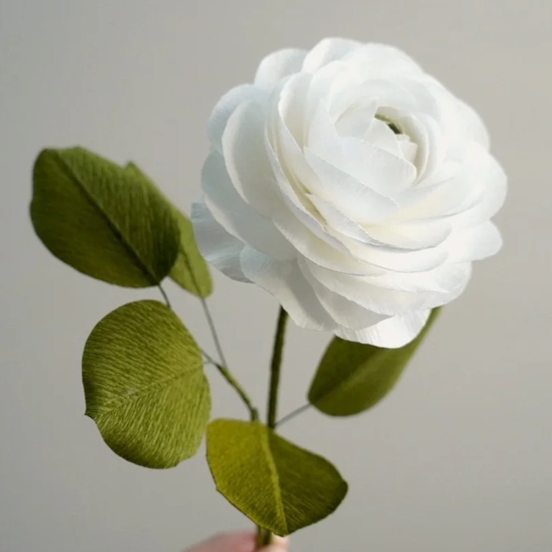 White realistic paper rose with green leaves handmade by Jasmine Sing, paper artist from Merremade.