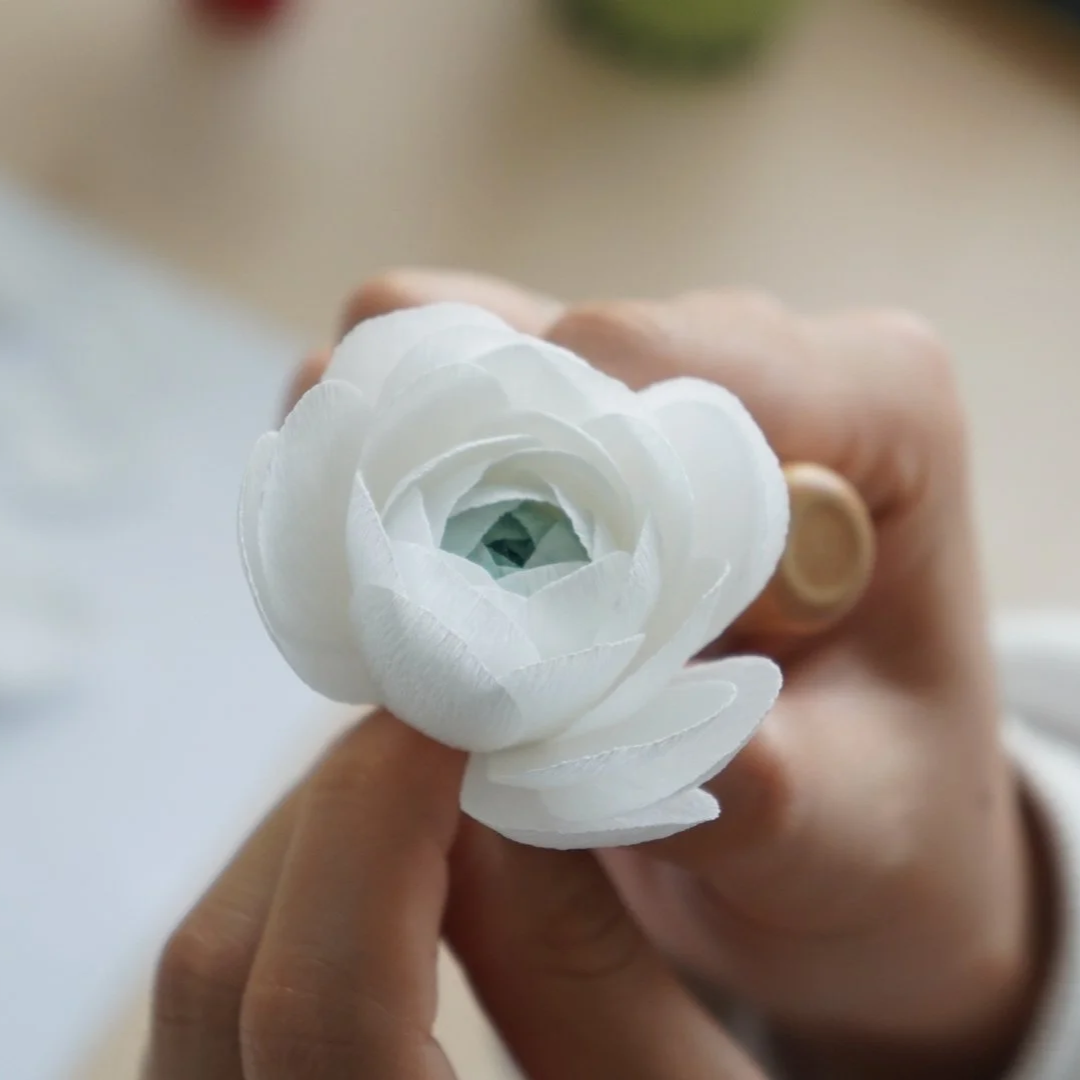 Merremade student working on paper ranunculus flower during in-person workshop in Seoul korea.