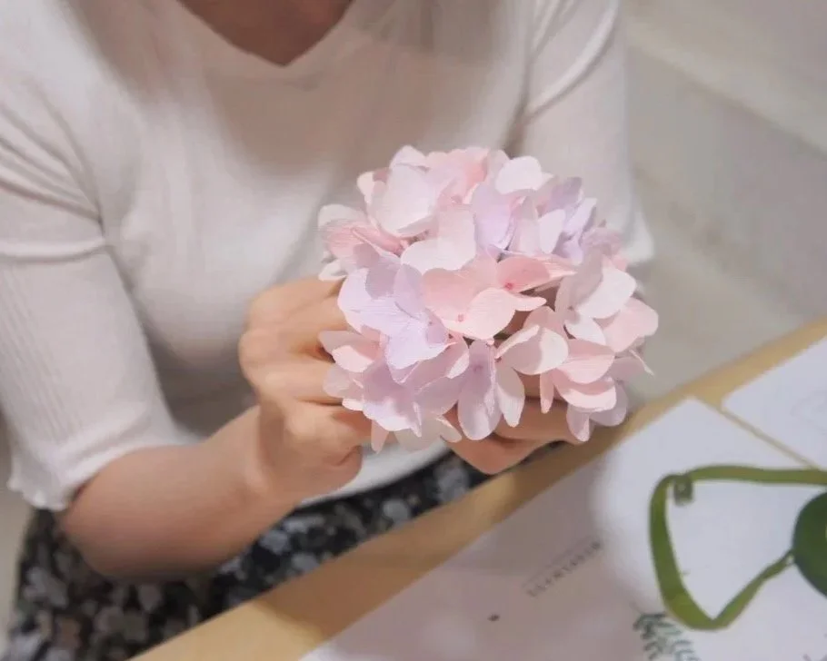 Merremade student making a bunch of pink paper hydrangea flowers in workshop Seoul Korea.