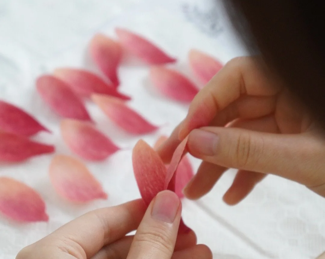 Close-up of Merremade student working on paper flower petals during workshop in Seoul Korea.