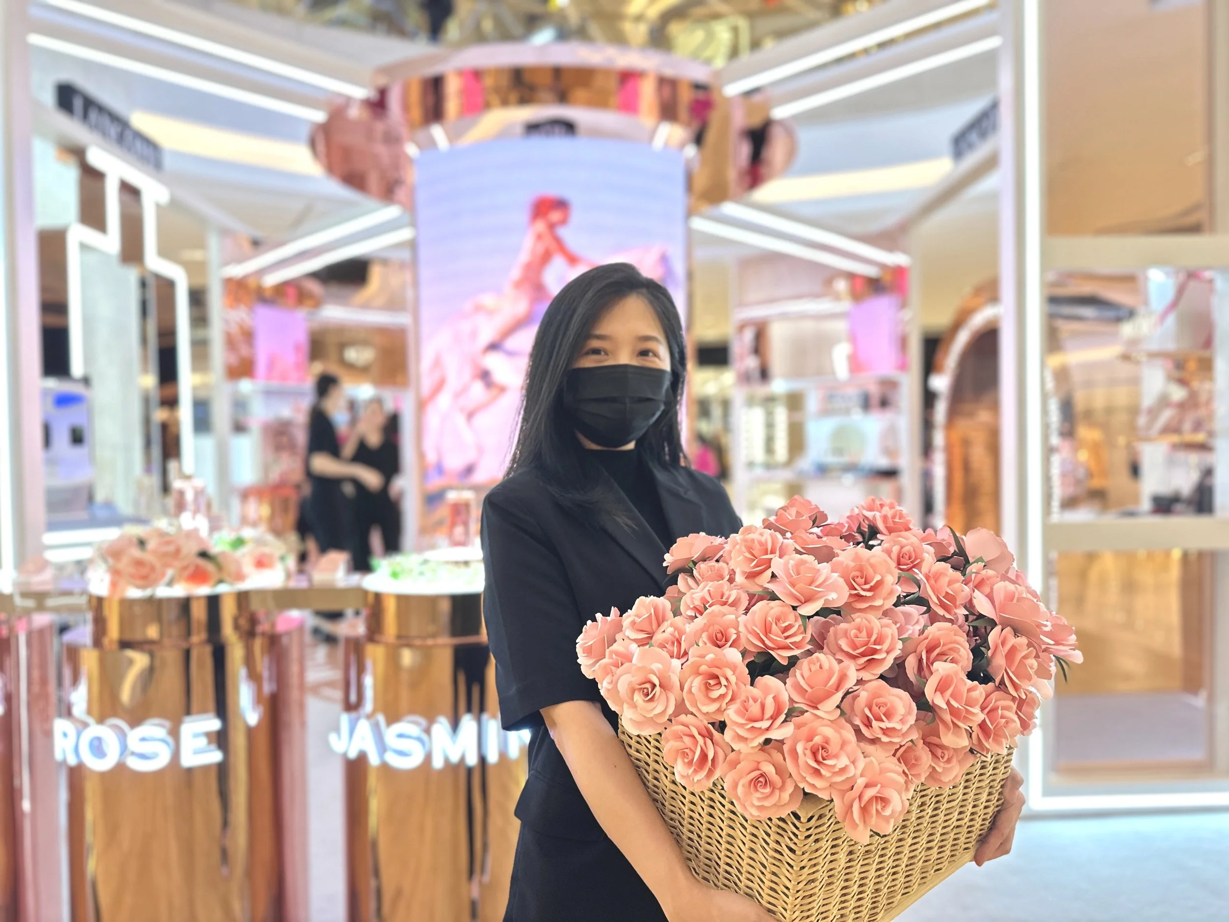 Jasmine Sing, paper artist from Merremade holding a large basket of pink paper roses inside Ion shopping mall Singapore for Lancome new perfume launch event.