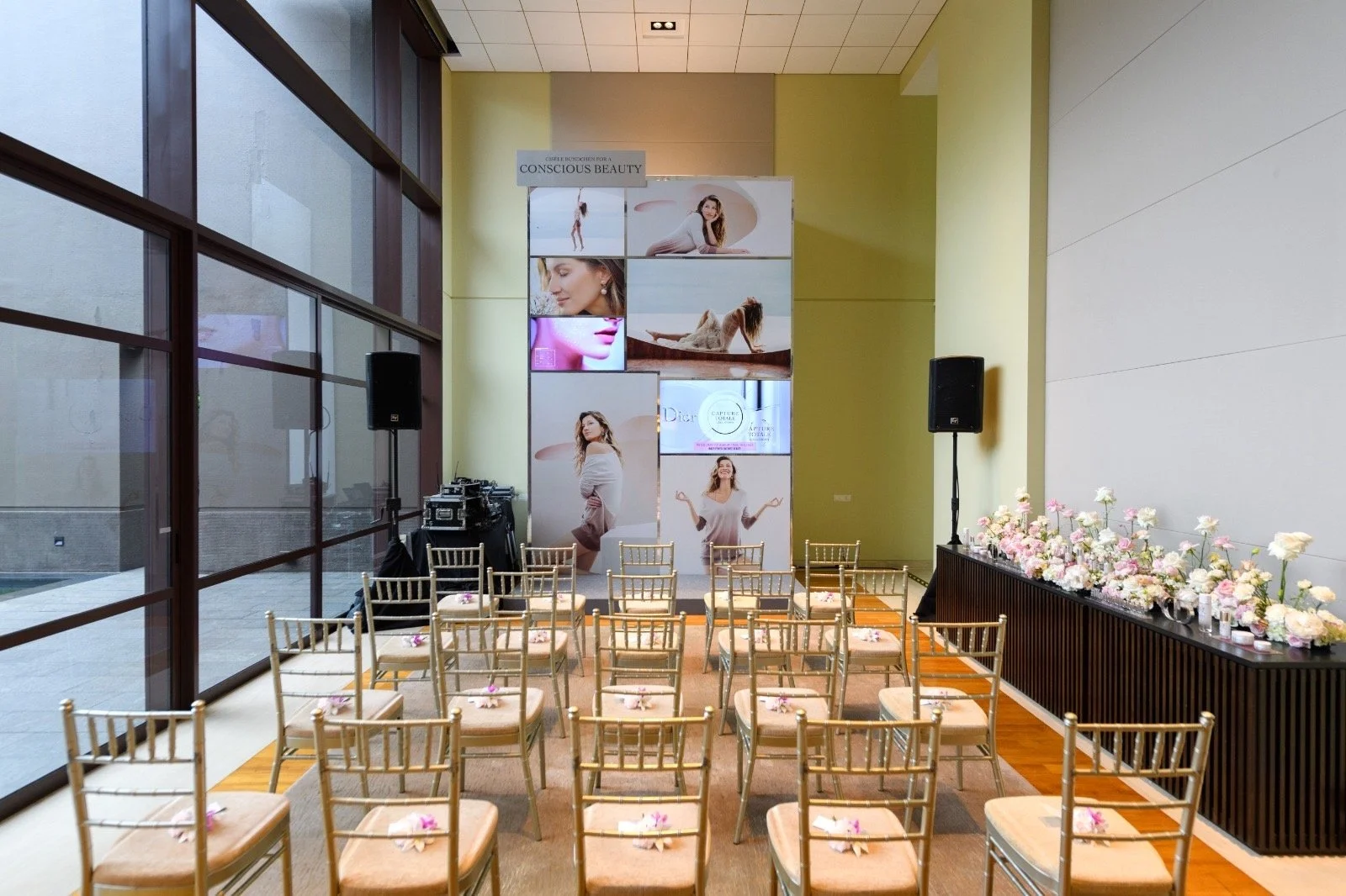 A decorated indoor event space with mini paper floral arrangements on every chair during a Dior event in Singapore.