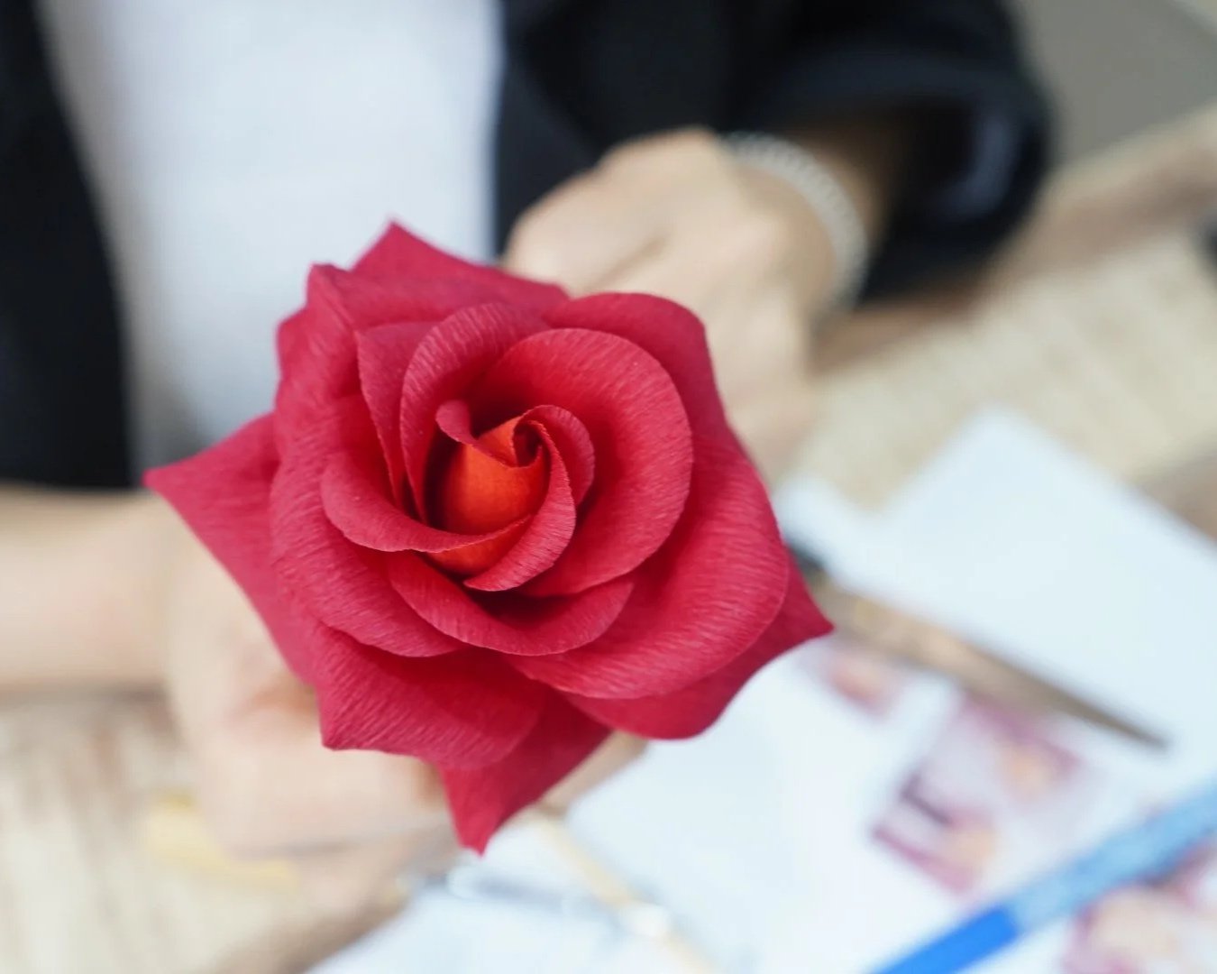 Close-up of a realistic red paper rose during a paper flower class in Seoul Korea.