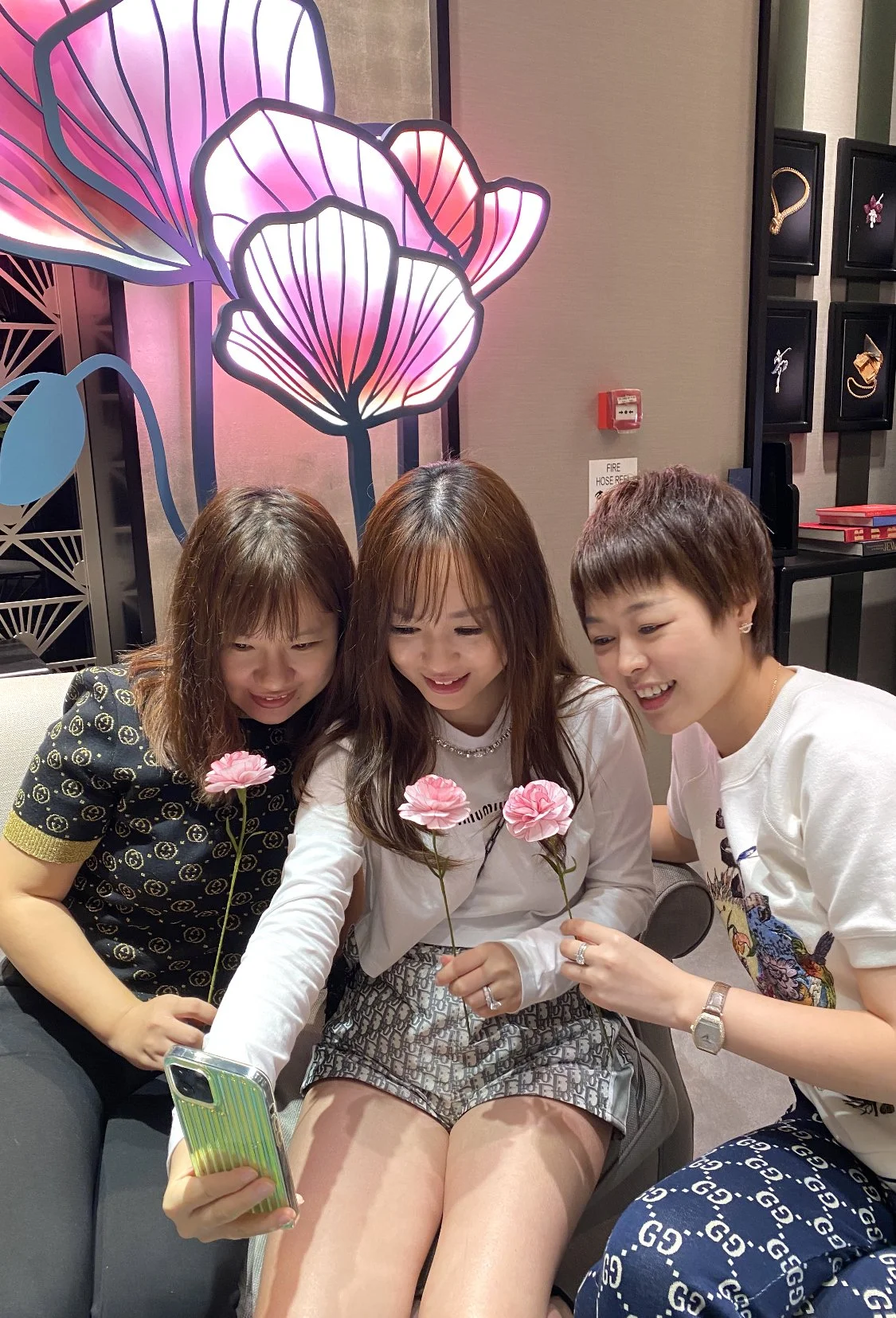 VIP guests taking photos of their completed handmade paper carnations at Van Cleef & Arpels Singapore event. 