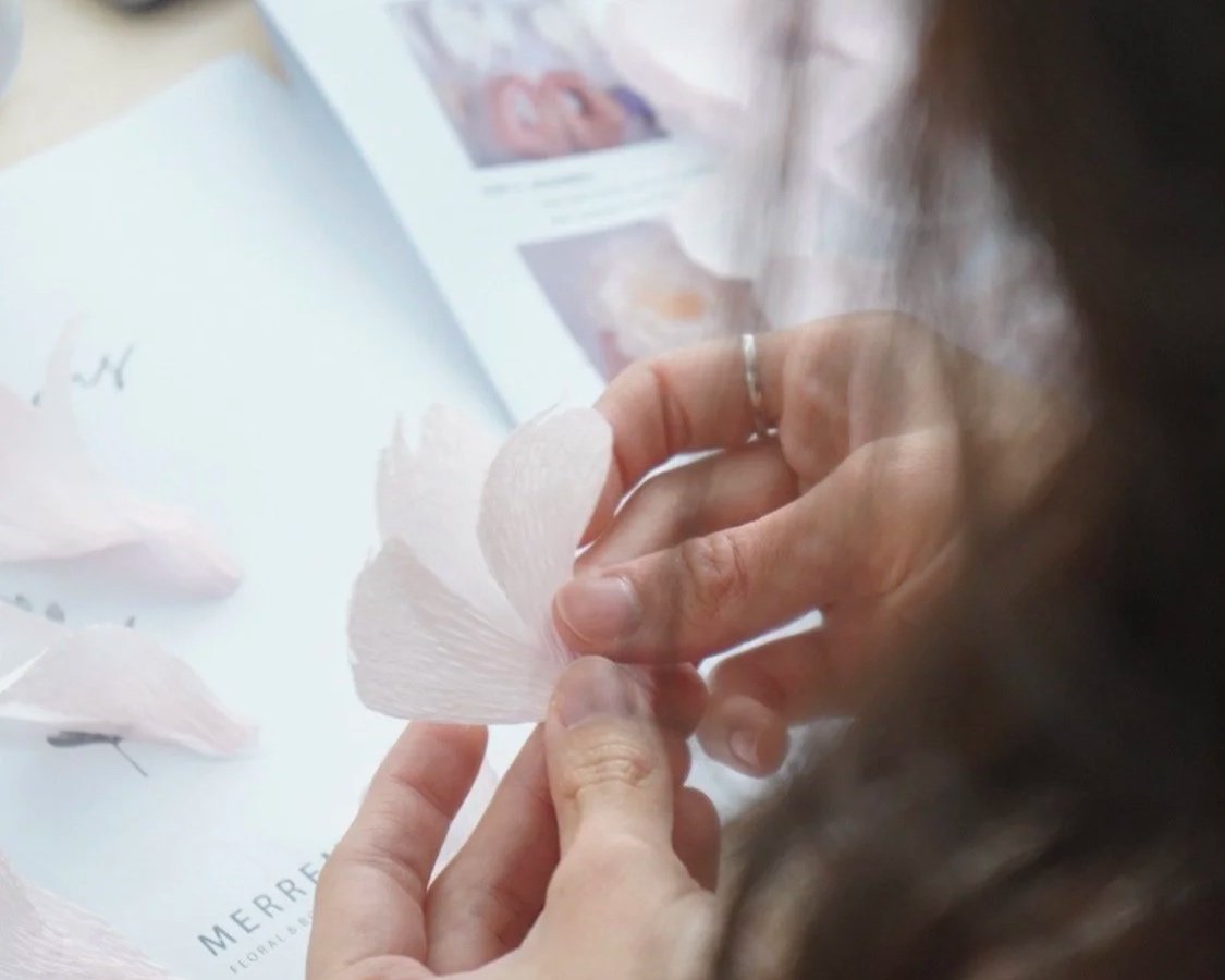 Merremade student handcrafting her paper flowers.