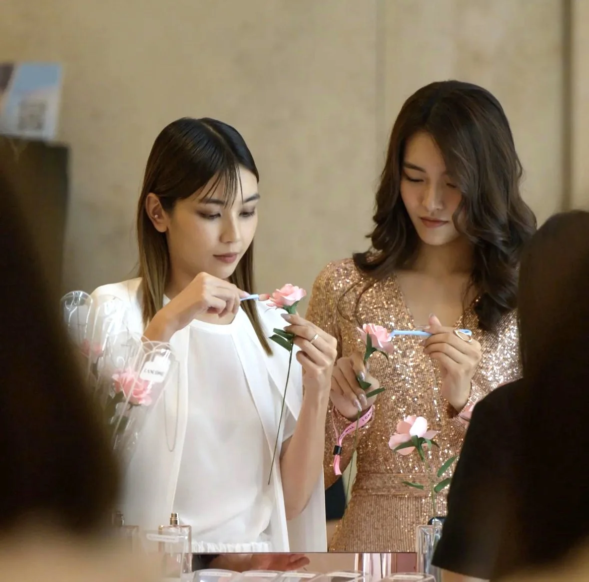 Singaporean actresses making paper flowers at Lancome new perfume launch event at Ion shopping mall Singapore.