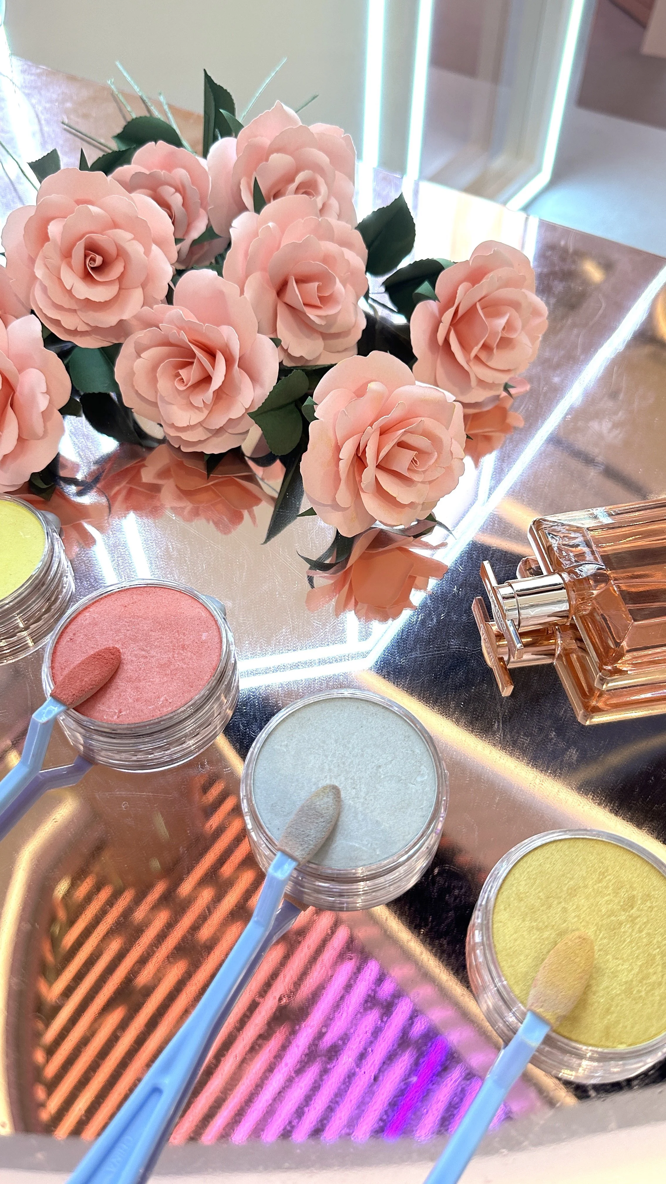 Pink paper roses with green leaves, displayed at Lancome event in Singapore Ion shopping mall.