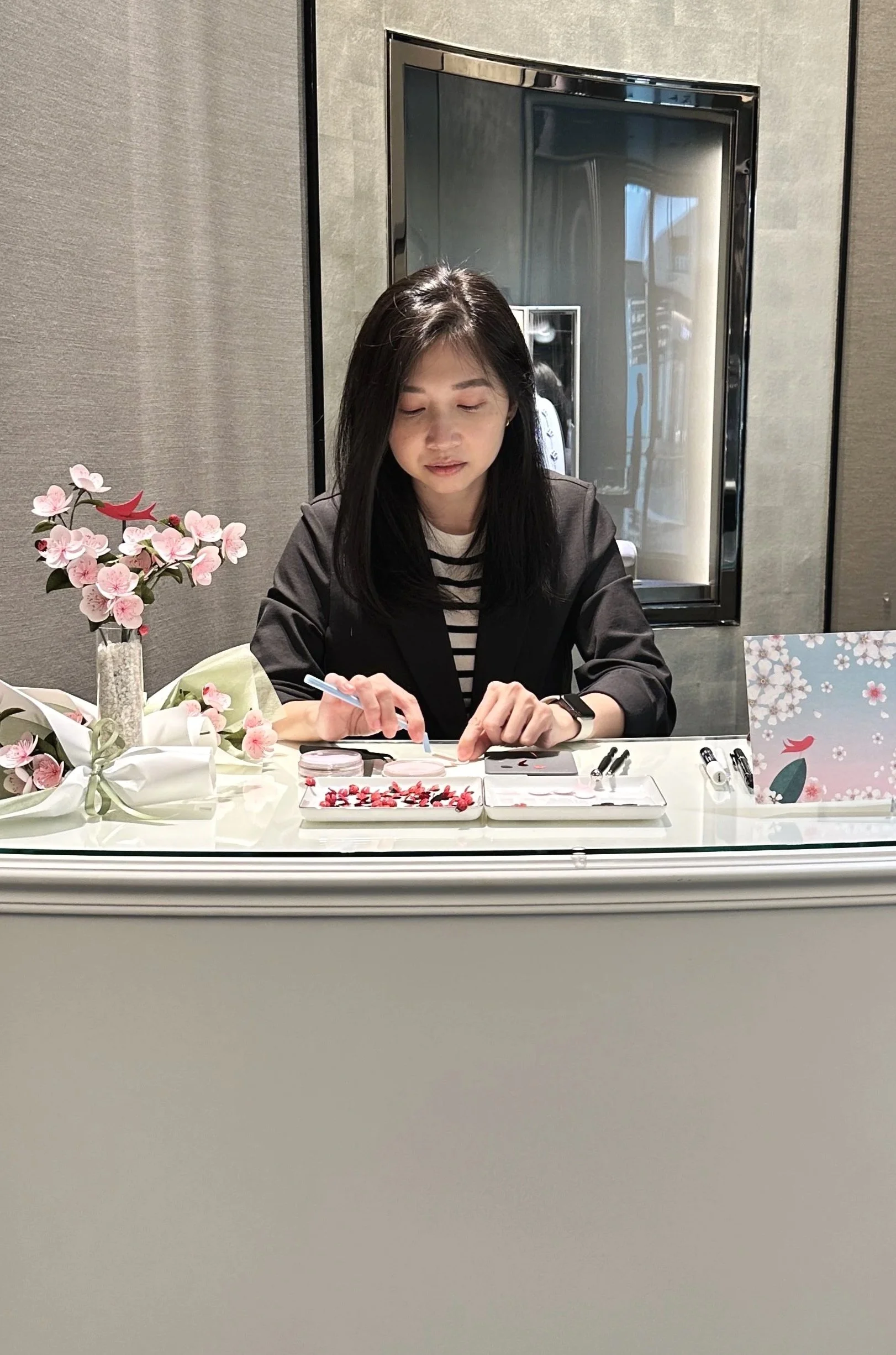 Jasmine Sing, paper artist giving live demonstrations making paper cherry blossoms at Van Cleef and Arpels boutique Singapore.