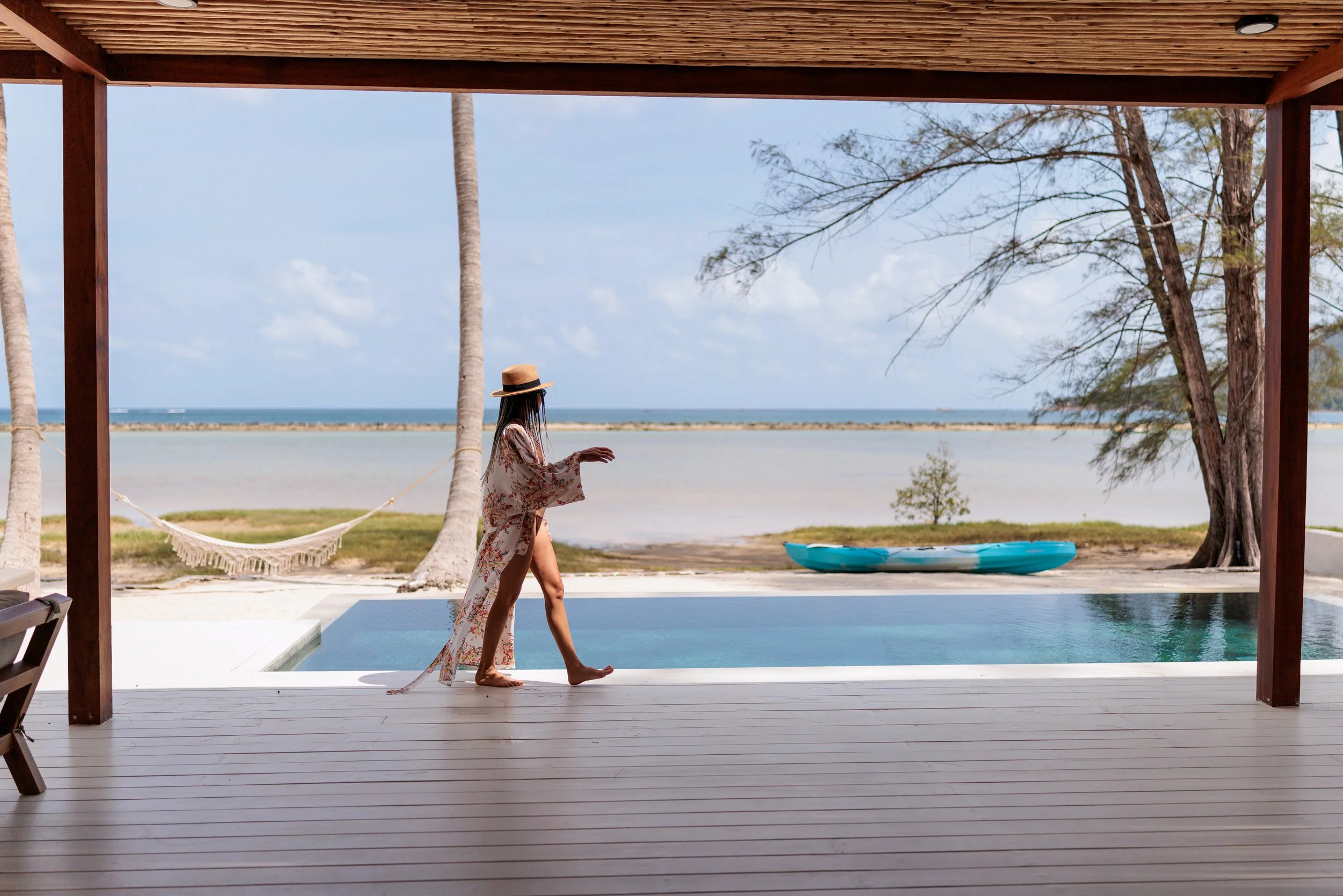 woman walks by pool with ocean views