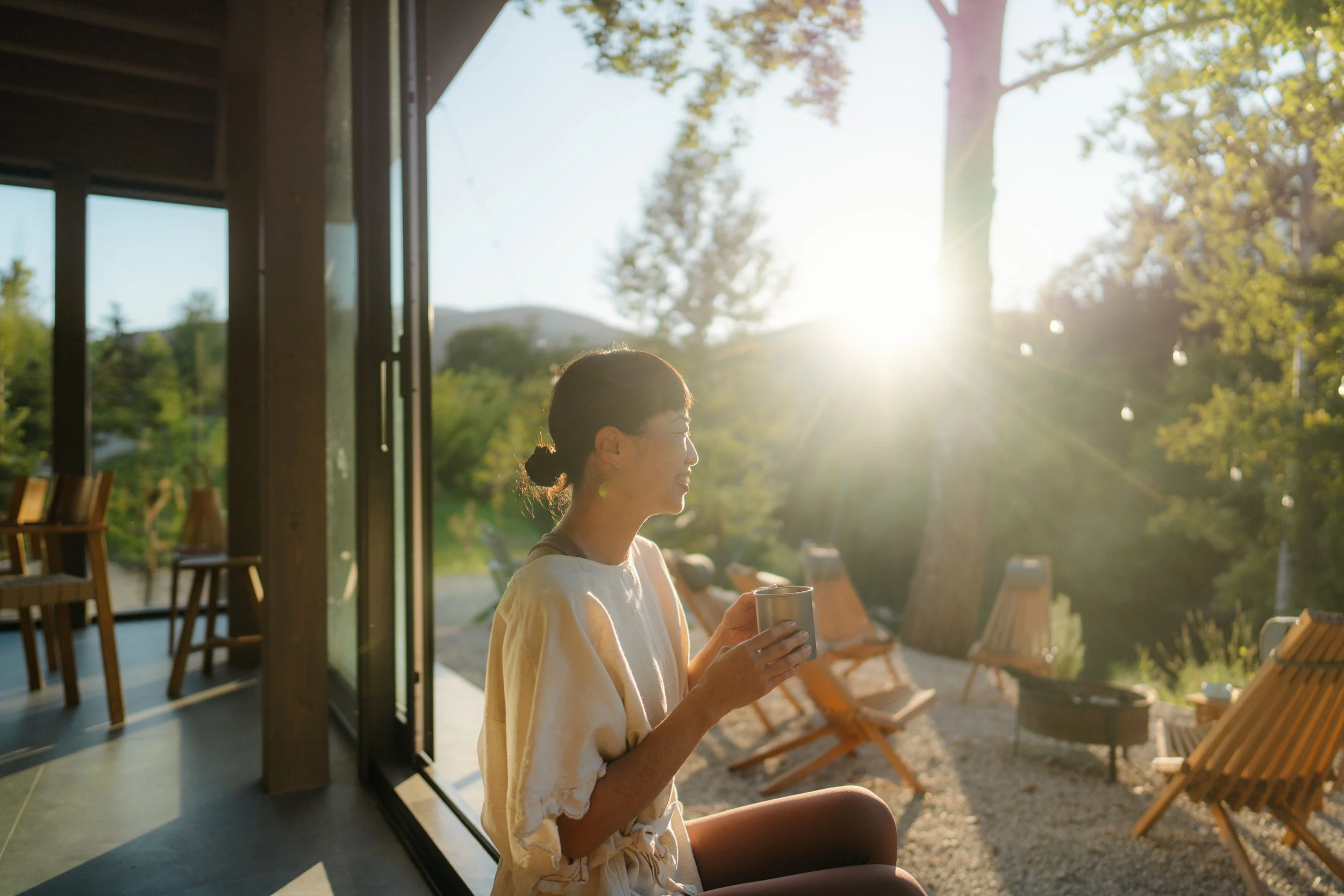 woman enjoying coffee and mountain views