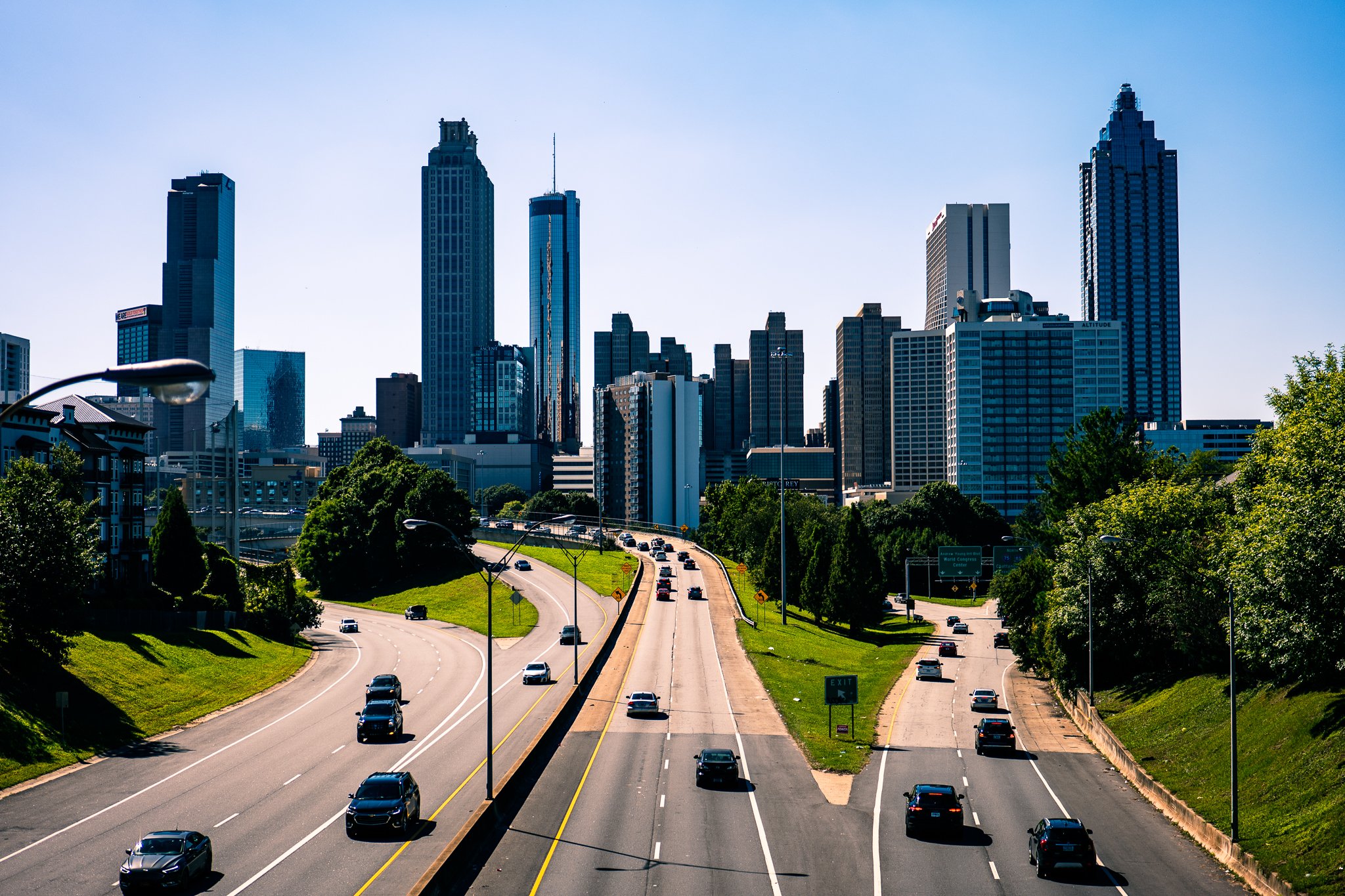 Cityscape of Atlanta, Georgia, featuring skyscrapers and a highway with cars.