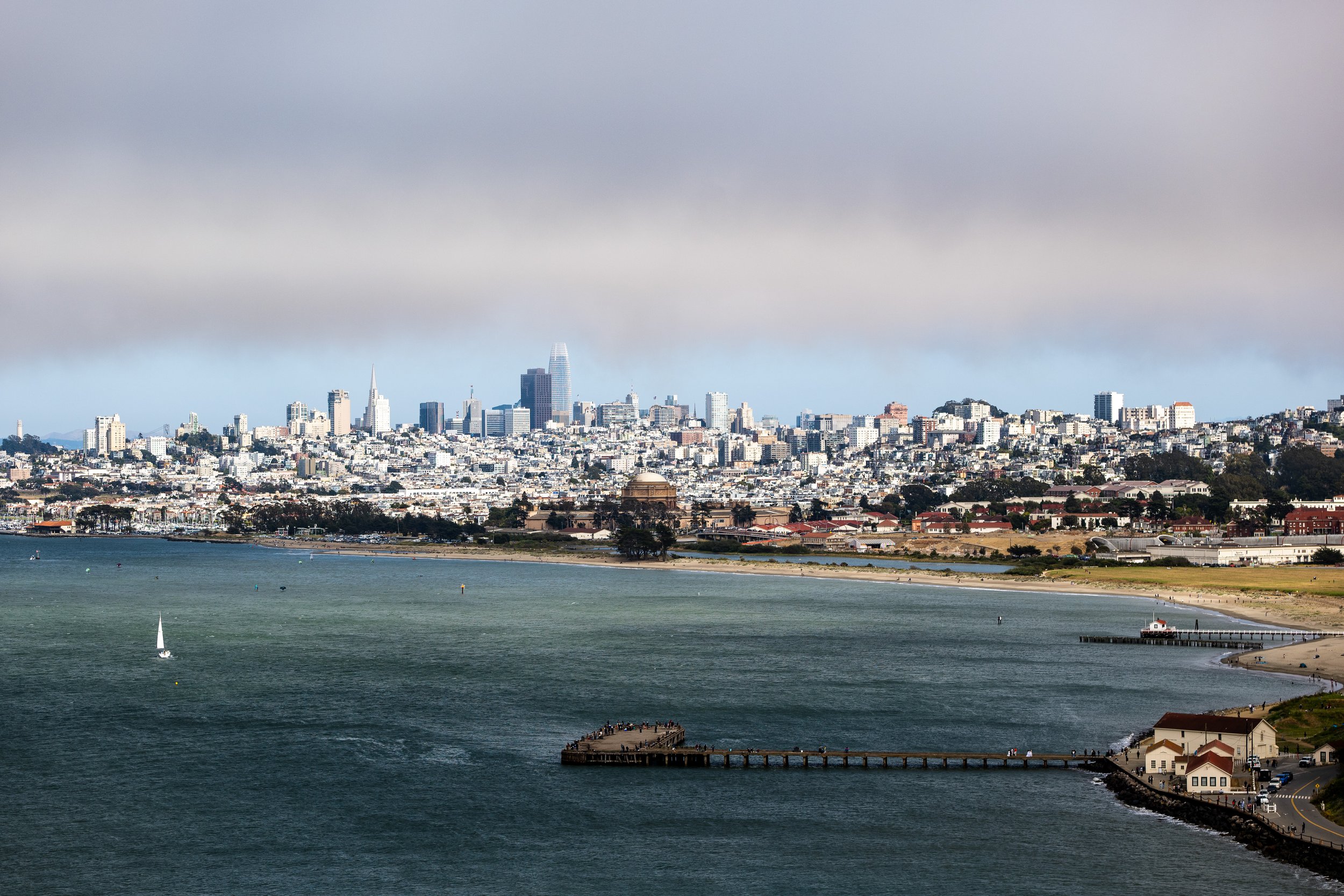 San Francisco skyline with bay, pier, and distant cityscape.