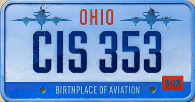 Ohio license plate with registration number CIS 353, featuring blue and orange colors, and the slogan 'Birthplace of Aviation' at the bottom.