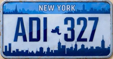 New York license plate with the characters 'ADI 327' and a small boot graphic above the number.