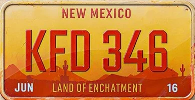 A New Mexico license plate with the number KFD 346, featuring a desert landscape with mountains, cacti, and a sunset, and a slogan 'Land of Enchantment' at the bottom.