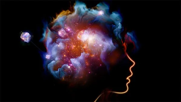 An artistic illustration of a human head in profile with a colorful galaxy and nebula imagery representing thoughts or imagination.