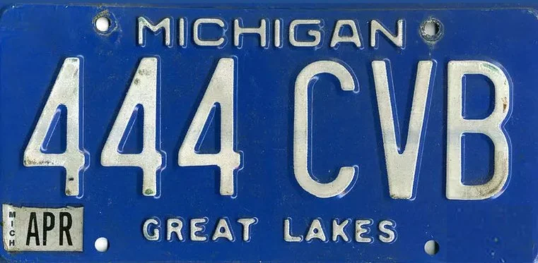 A Michigan license plate with the number 444 CVB, issued in April, featuring the Great Lakes emblem.
