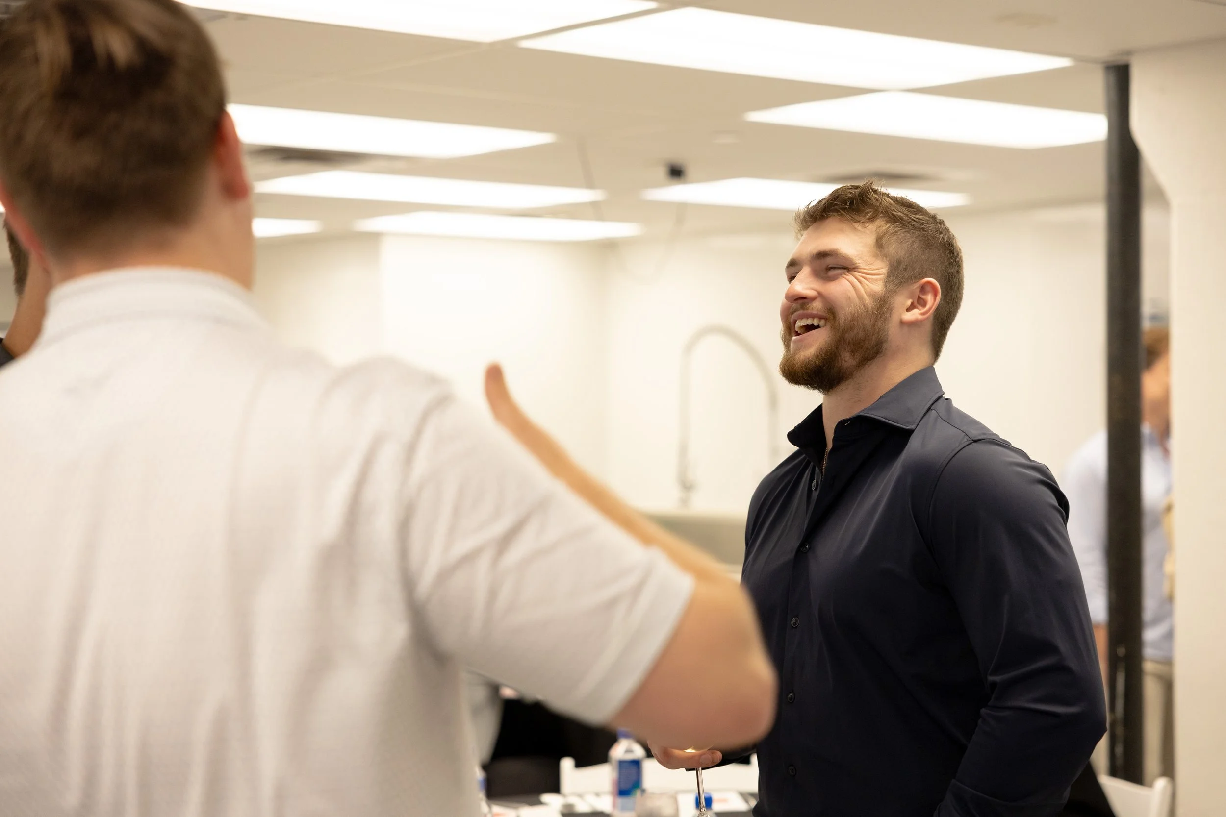 Individual laughing at the InvestCPG Welcome dinner while making connections with other guests