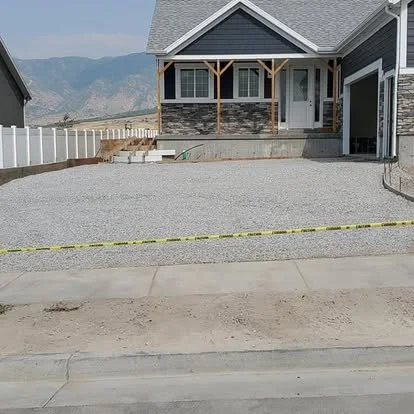 Driveway project in progress with a gravel base prepared and ready for concrete installation.
