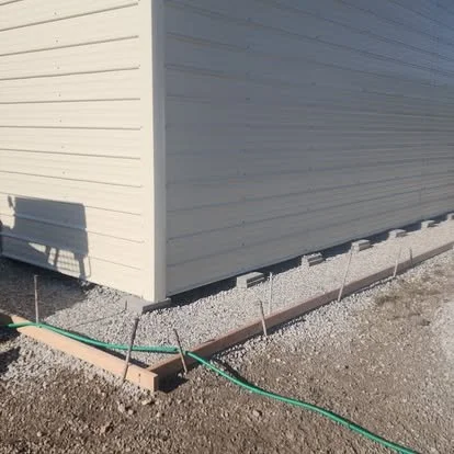 Walkway preparation with forms, gravel base, and layout work ready for concrete installation.
