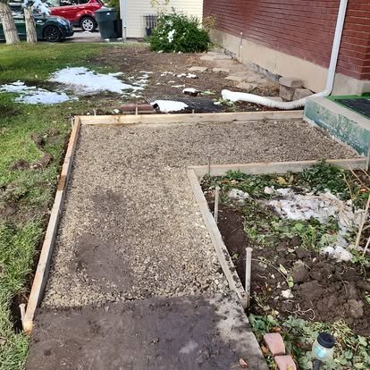 Walkway project in progress with forms and base preparation before the concrete pour.