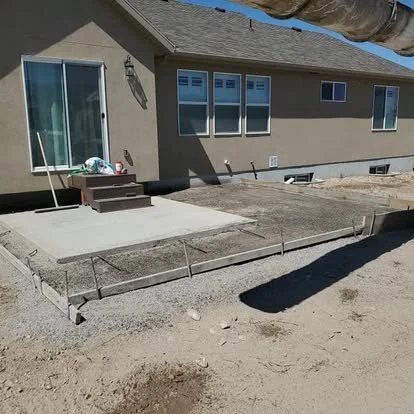 Patio project in progress with forms placed and the area prepared for a new concrete pour.