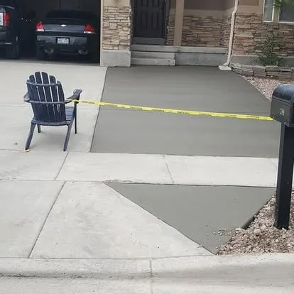 Finished front walkway and entry approach with smooth concrete, clean edges, and a curbside transition.