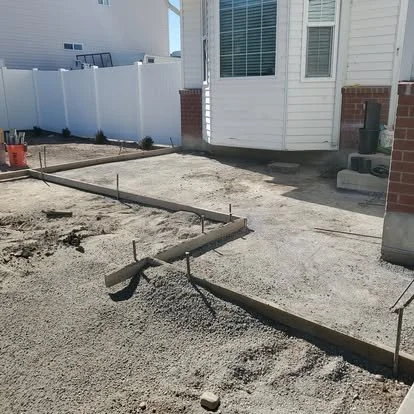 Walkway and small patio preparation with forms, gravel base, and the area ready for concrete installation.