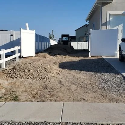 RV pad or driveway extension preparation with dirt work and grading underway before concrete installation.