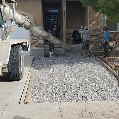 Concrete delivery and prep work in progress with a gravel base ready for a new driveway or walkway pour.