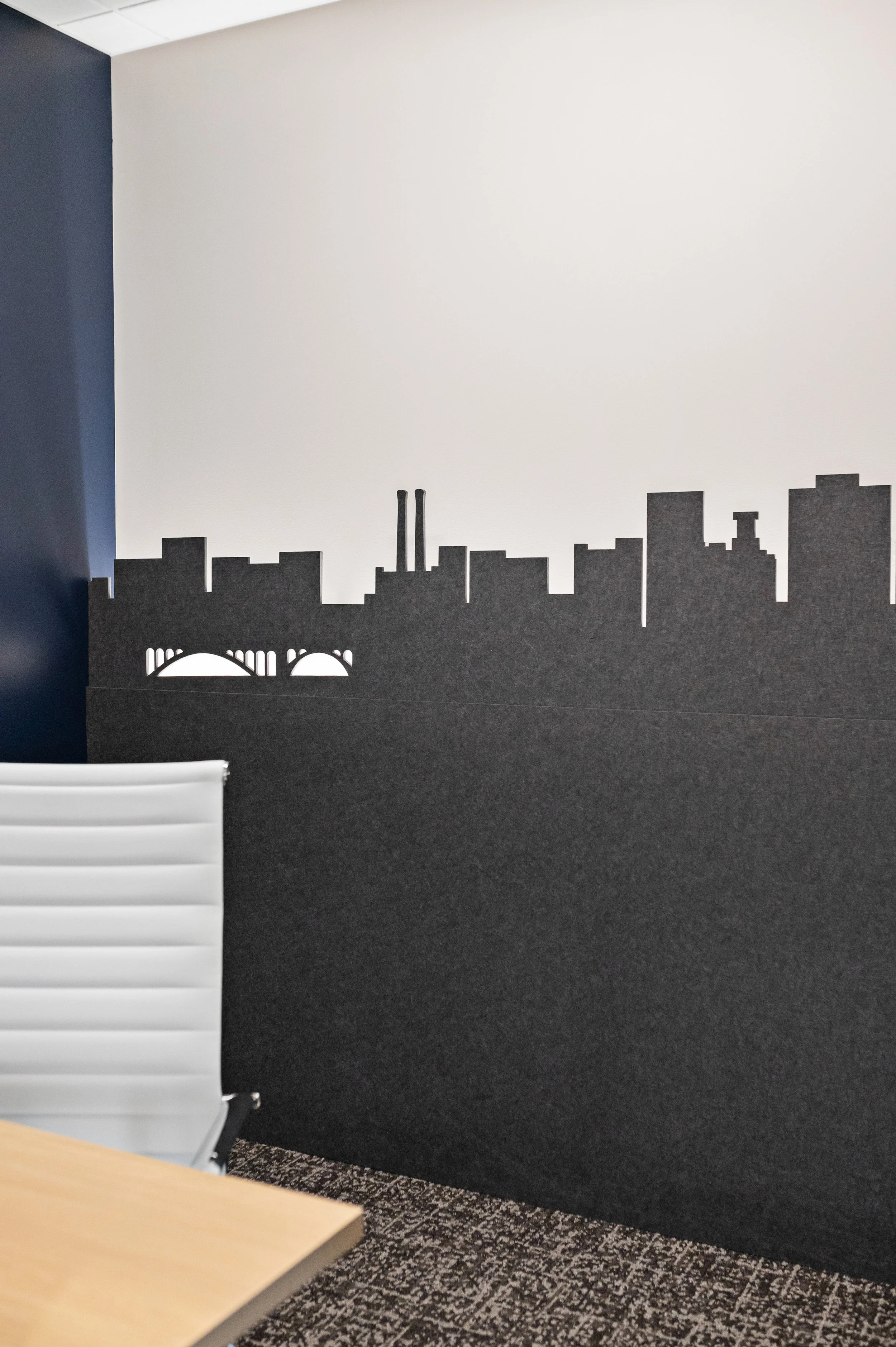 Office meeting room with a cityscape silhouette decal on a black wall