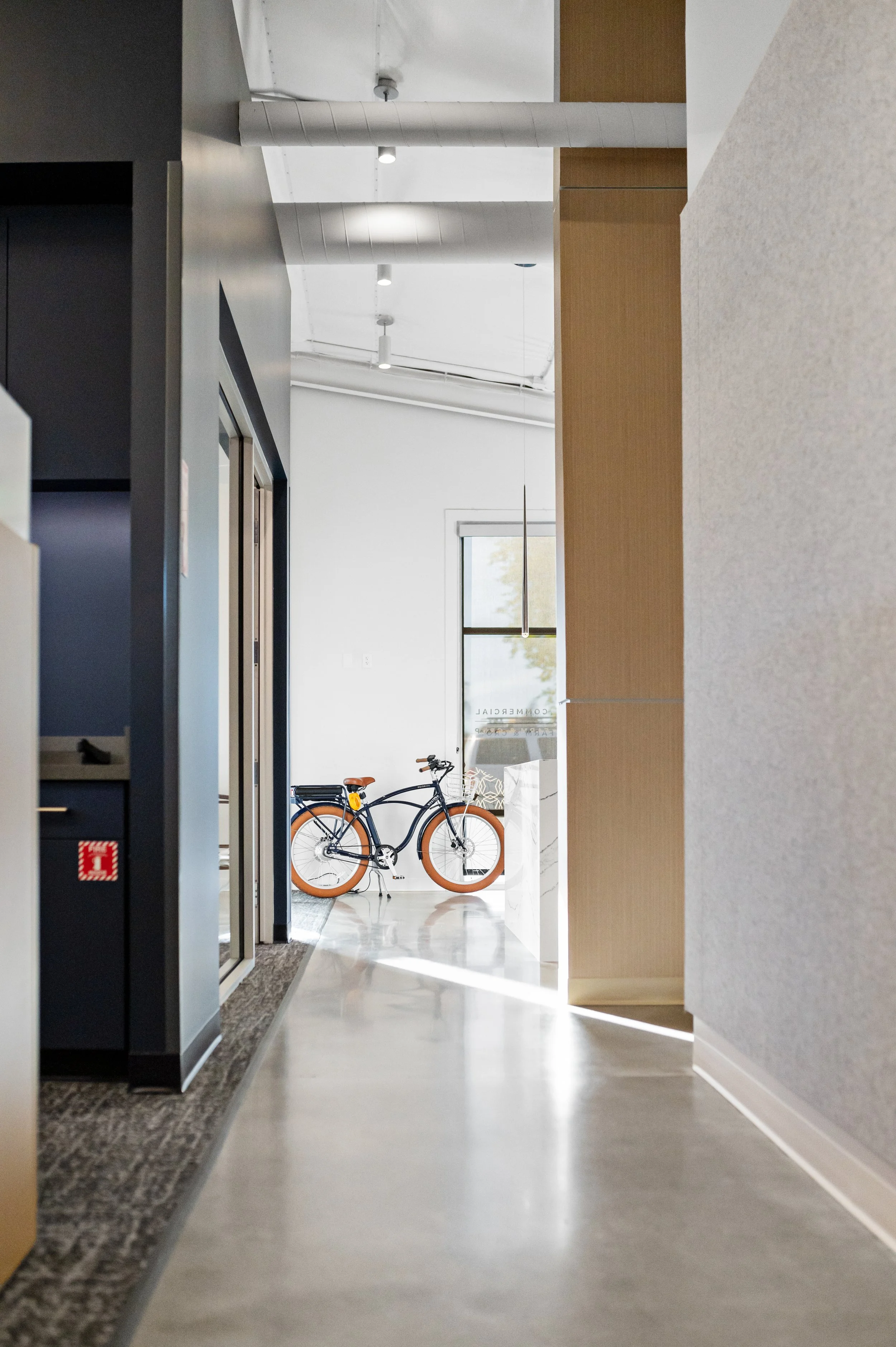Western Insurance indoor view of a modern building corridor with a bicycle parked near the entrance