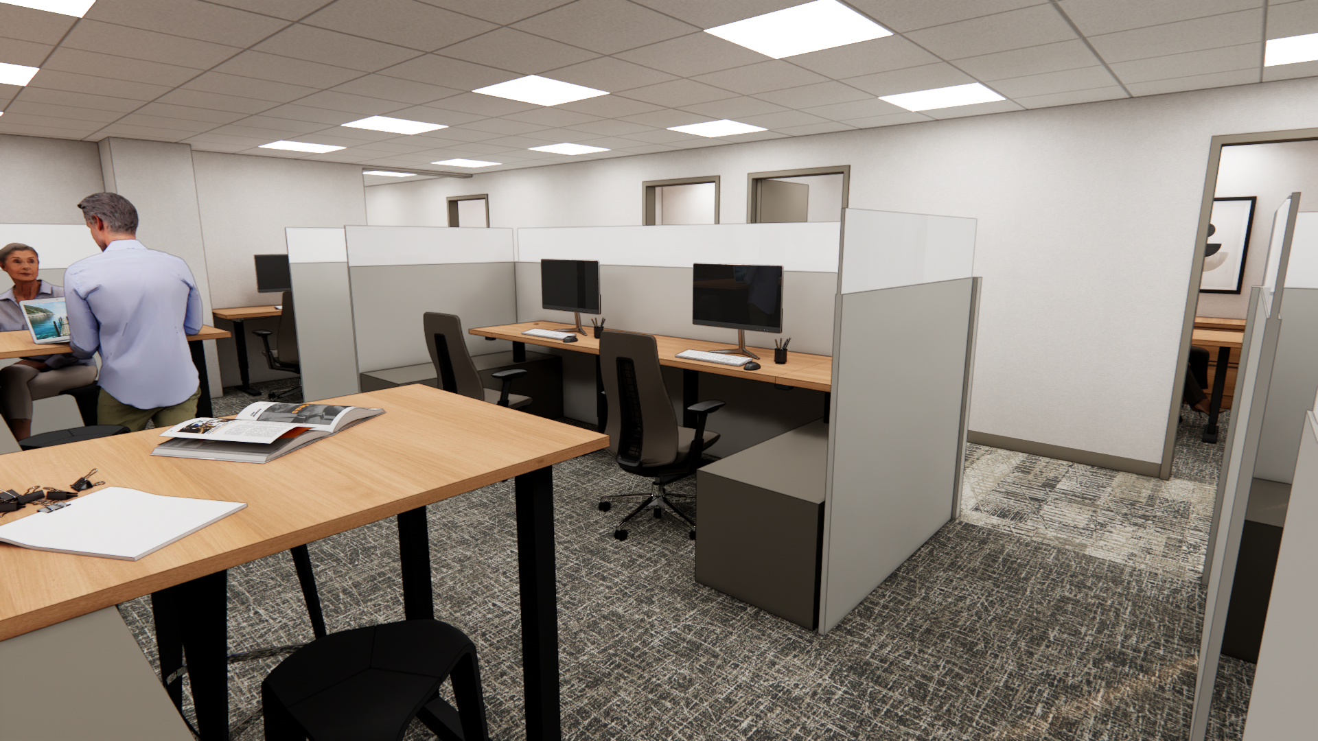 Interior of a modern office space with cubicles, desks with monitors, and a meeting area