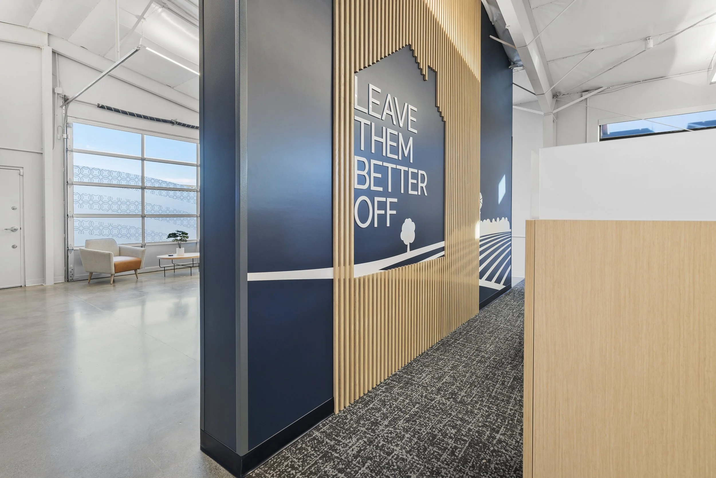 Western Insurance interior of a modern office with a wall sign that says 'Leave Them Better Off' in large white letters