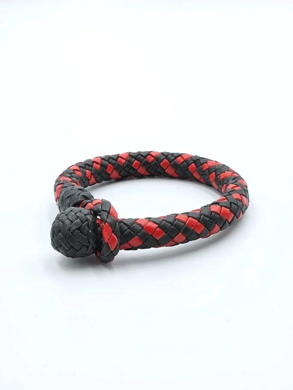 Black and red braided leather bracelet with a knot at one end, on a white background.