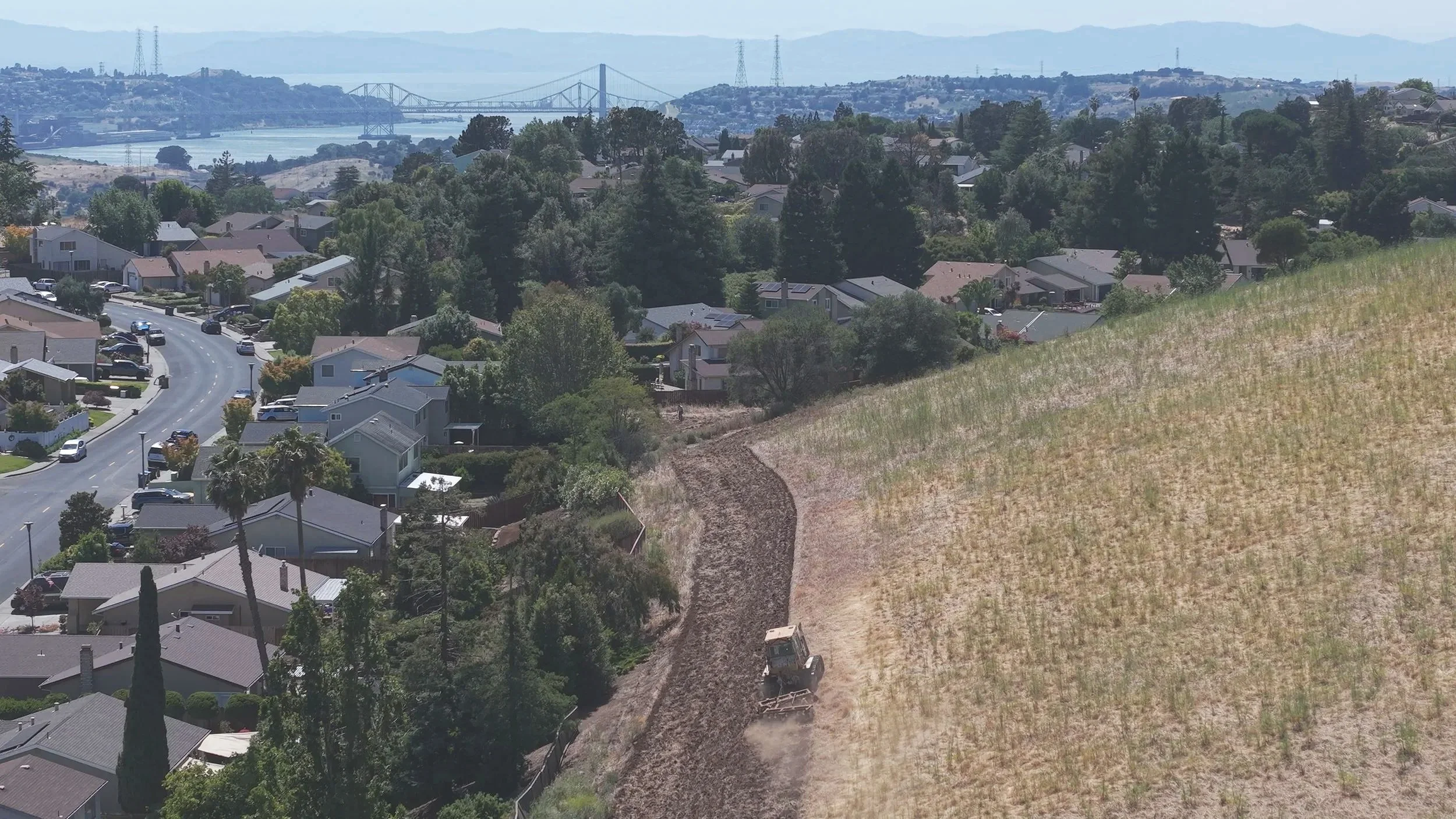 Fire Breaks created by discing 30ft - 40ft fuel breaks near residential houses and streets in a suburban neighborhood. Discing fuel breaks Napa County