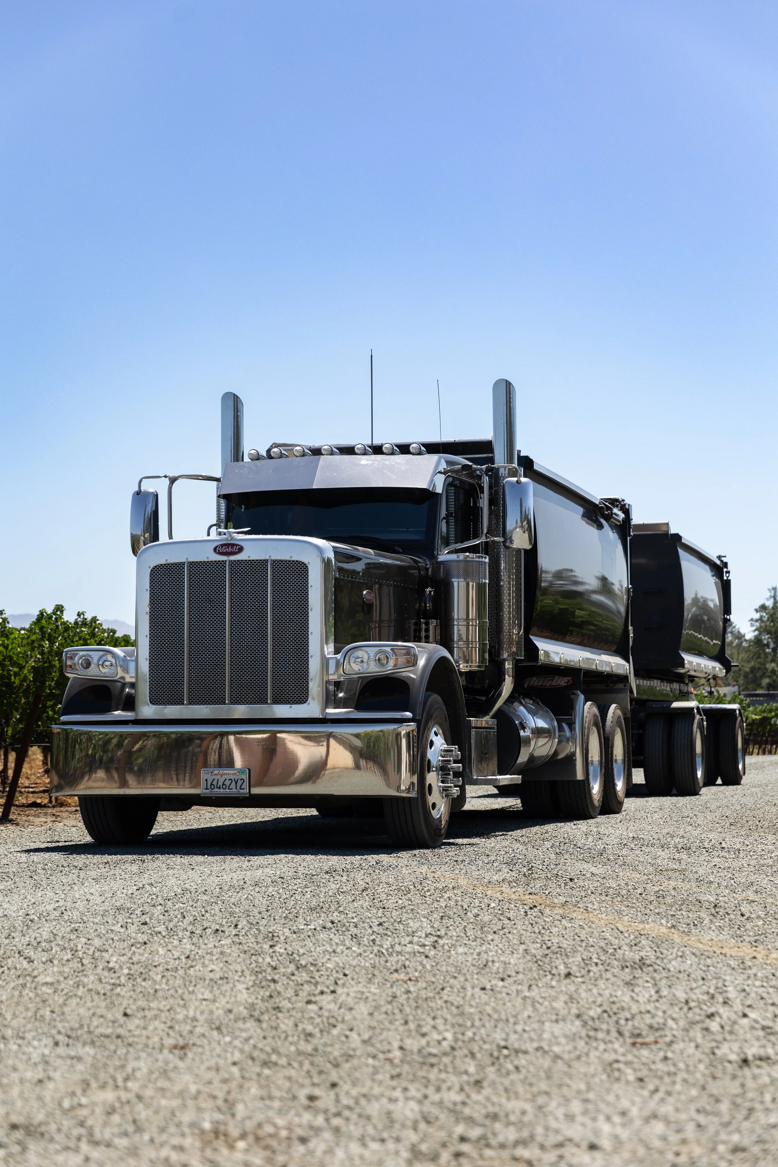 A large black Peterbilt Transfer truck with chrome details. Transfer Truck Services in Northern California.