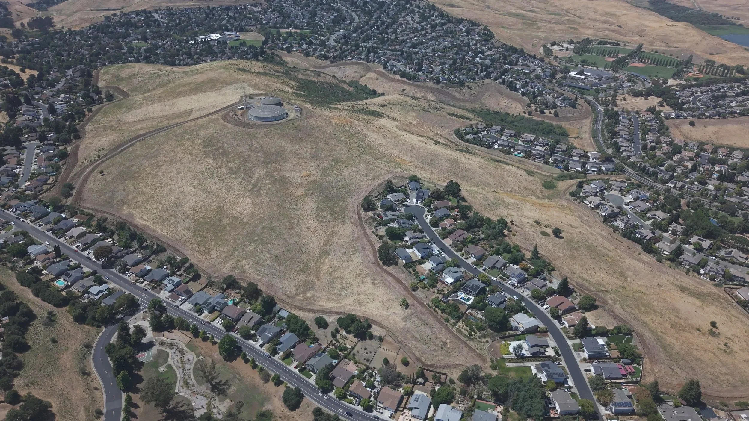 Fire Breaks created by discing 30ft - 40ft fuel breaks near residential houses and streets in a suburban neighborhood. Discing fuel breaks Sonoma County