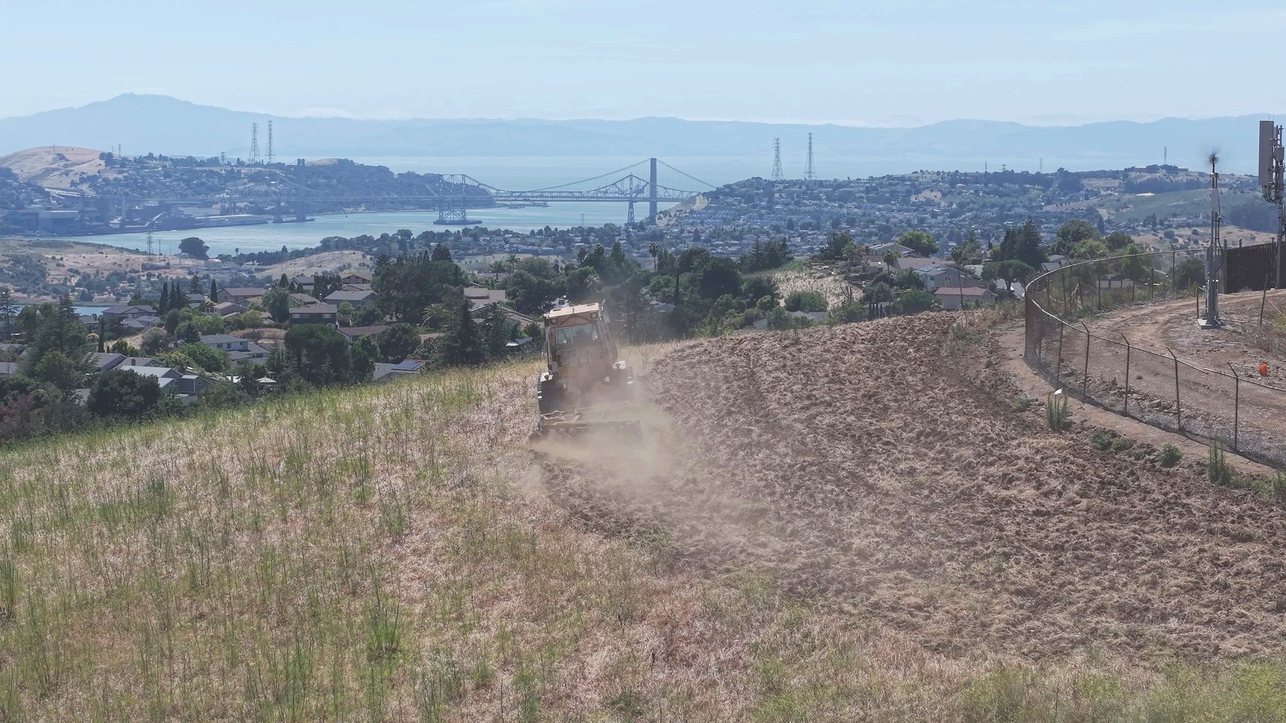 Fire Breaks created by discing 30ft - 40ft fuel breaks near residential houses and streets in a suburban neighborhood. Discing fuel breaks Benica