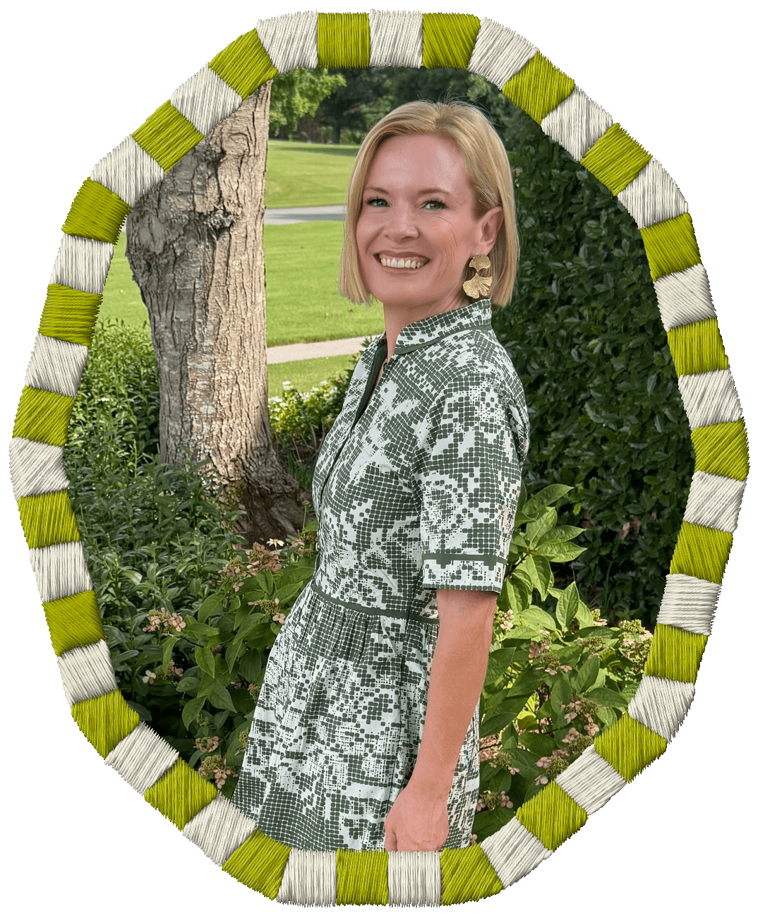 Rachel Smalley with blonde hair smiling outdoors, wearing a patterned dress and gold earrings, standing among bushes and trees with a park visible in the background, framed by an oval border with alternating white and yellow-green segments.