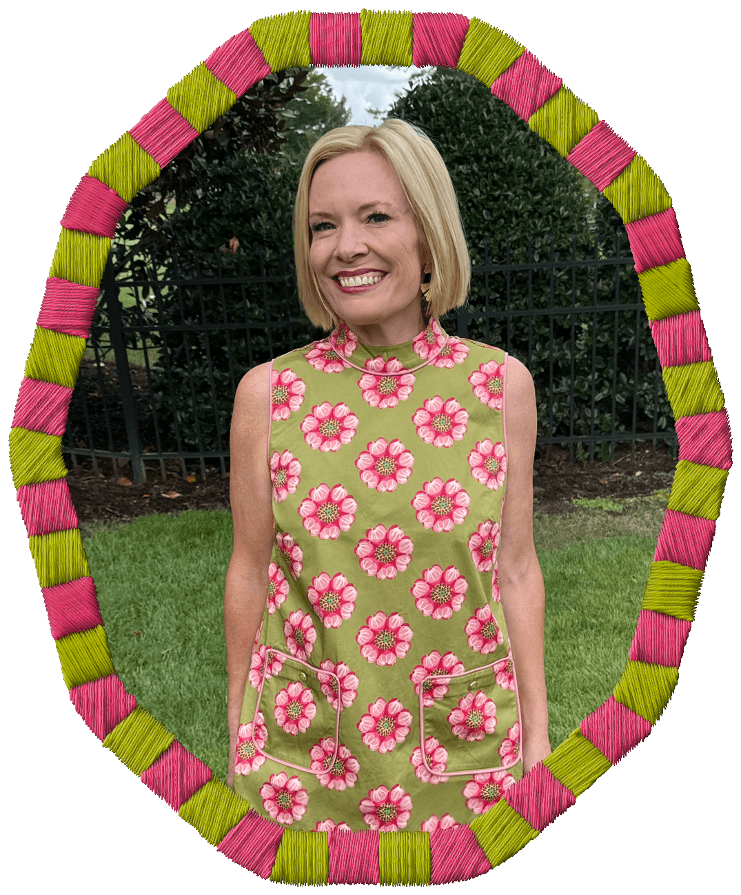 Rachel Smalley with blonde hair smiling and standing outdoors, wearing a green dress with pink floral patterns, framed by a colorful pink and yellow woven oval border.