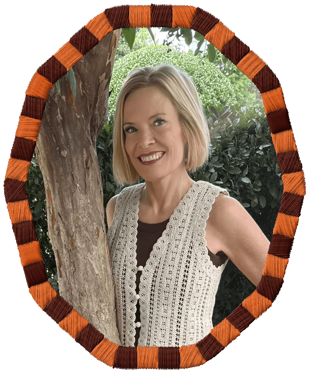 Rachel Smalley portrait, smiling in front of a tree with green foliage, wearing a sleeveless cream-colored crocheted top.
