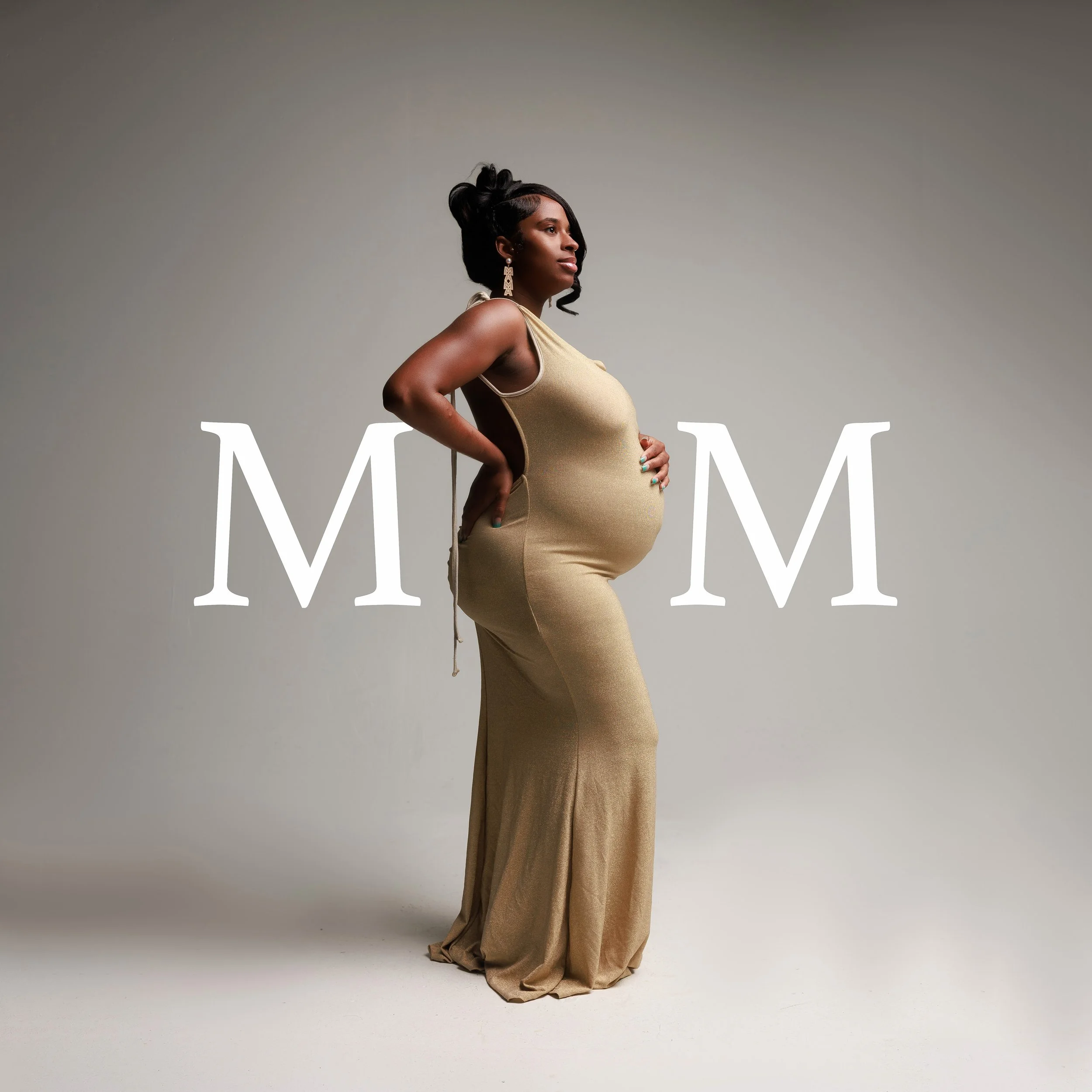 A pregnant woman wearing a gold evening gown and large earrings poses confidently against a neutral background.