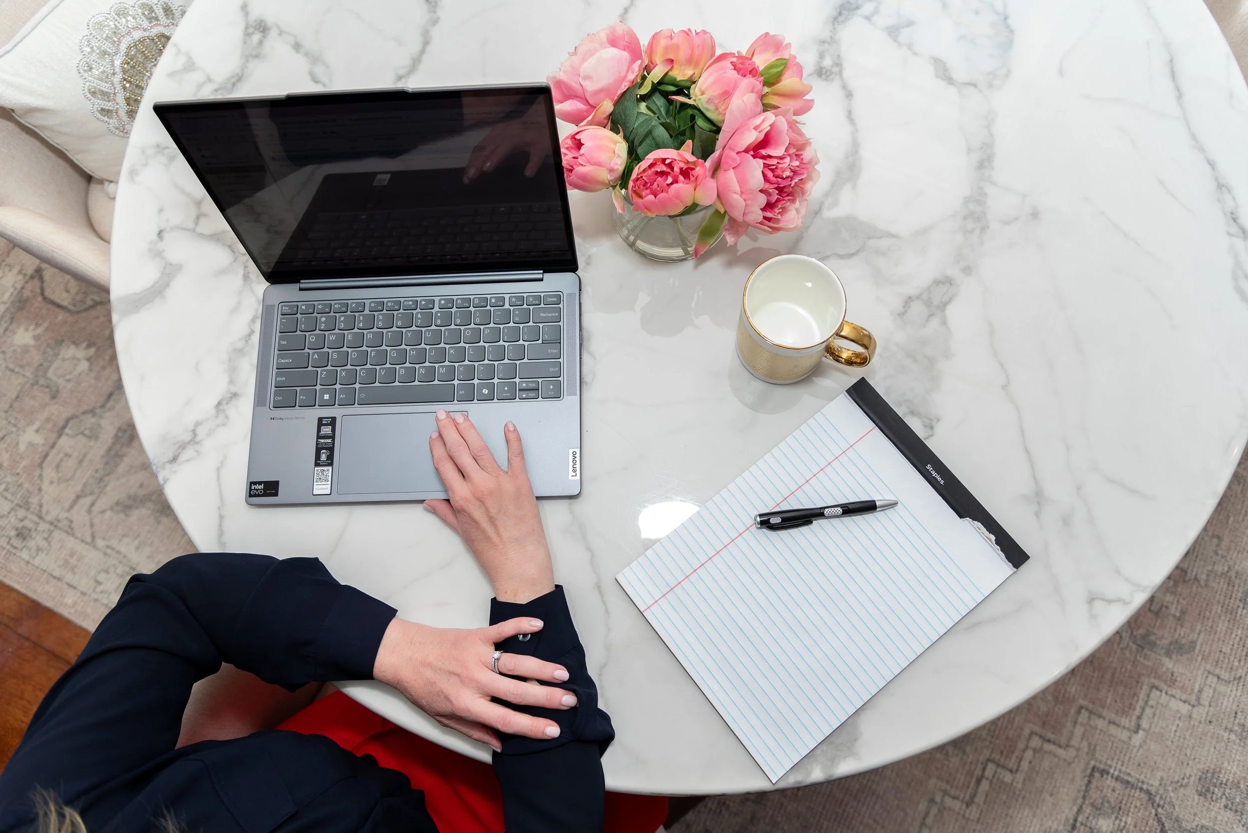 Civil law attorney workspace with laptop, notebook, and flowers, reflecting thoughtful divorce consulting and client support.