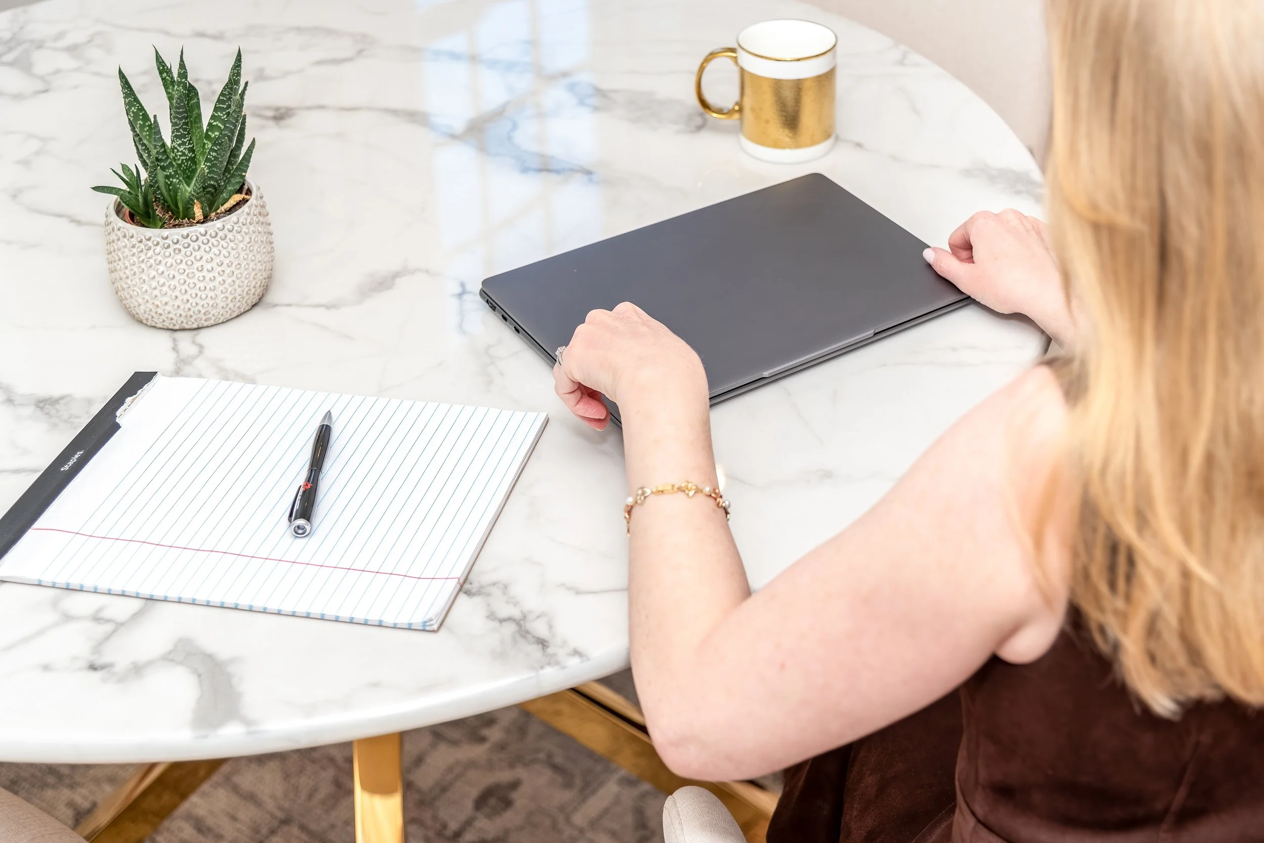 Divorce consulting workspace with notebook and laptop, representing calm guidance through collaborative divorce in Massachusetts.