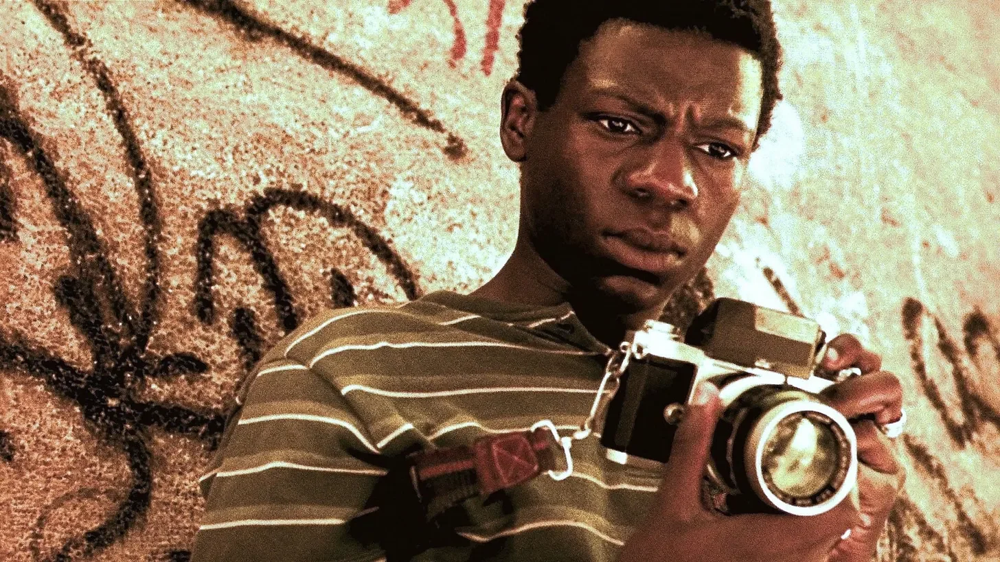 Boy holding a camera from the film City of God