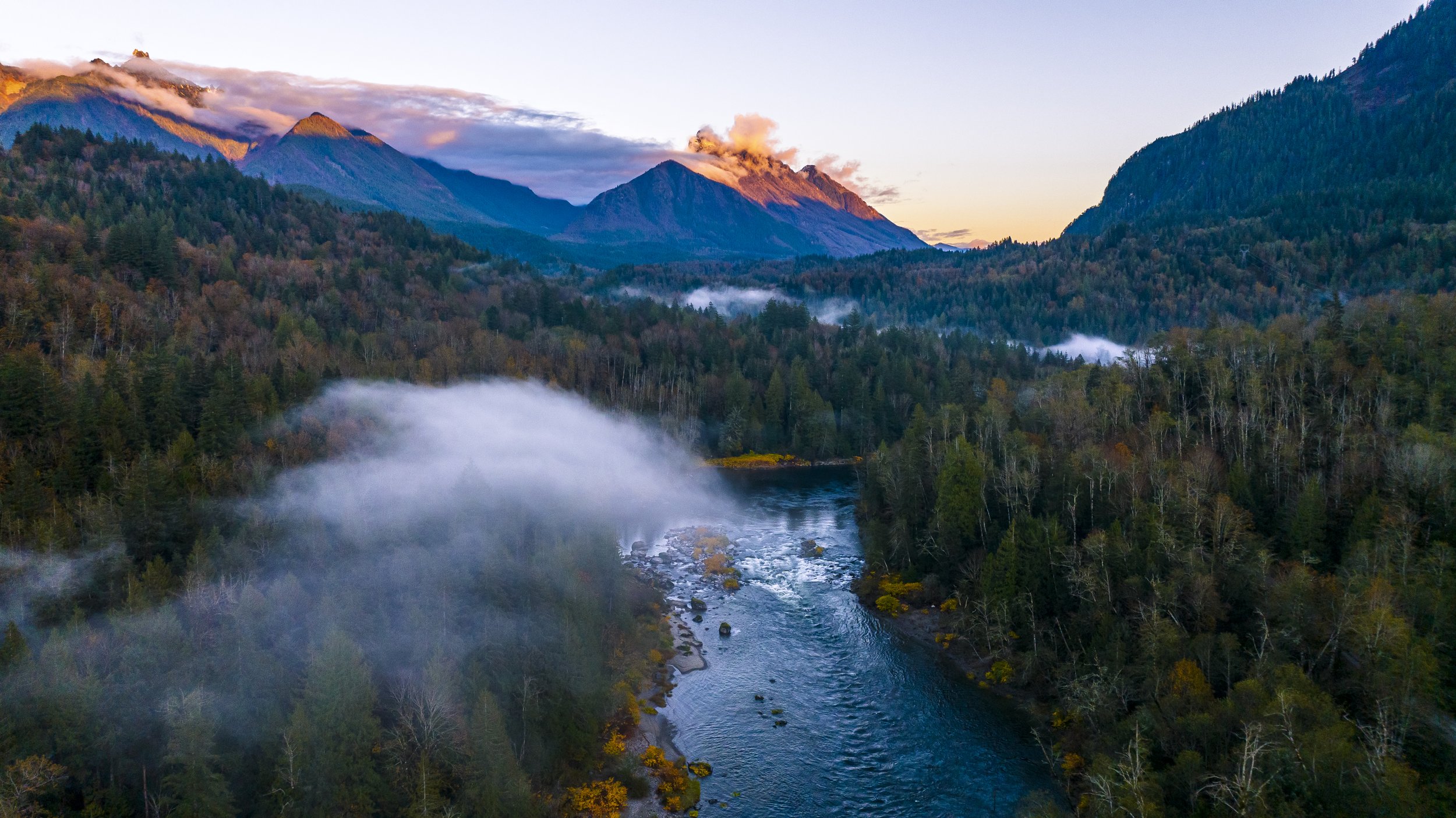 Aerial view of Pacific Northwest river valley with mountains and morning mist — ODHS funded EMDR consultation scholarship EMDR Resource Center Oregon