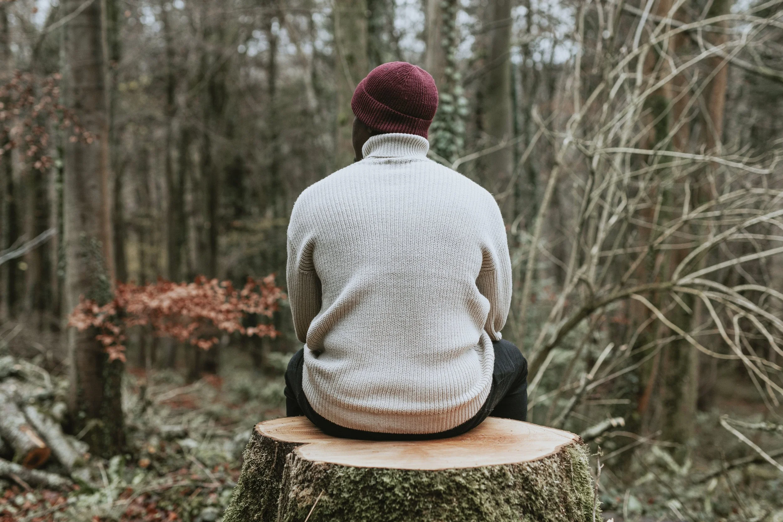 Man of color sitting quietly in Pacific Northwest forest — therapy for adolescents and adults navigating trauma and anxiety at EMDR Resource Center Portland Oregon